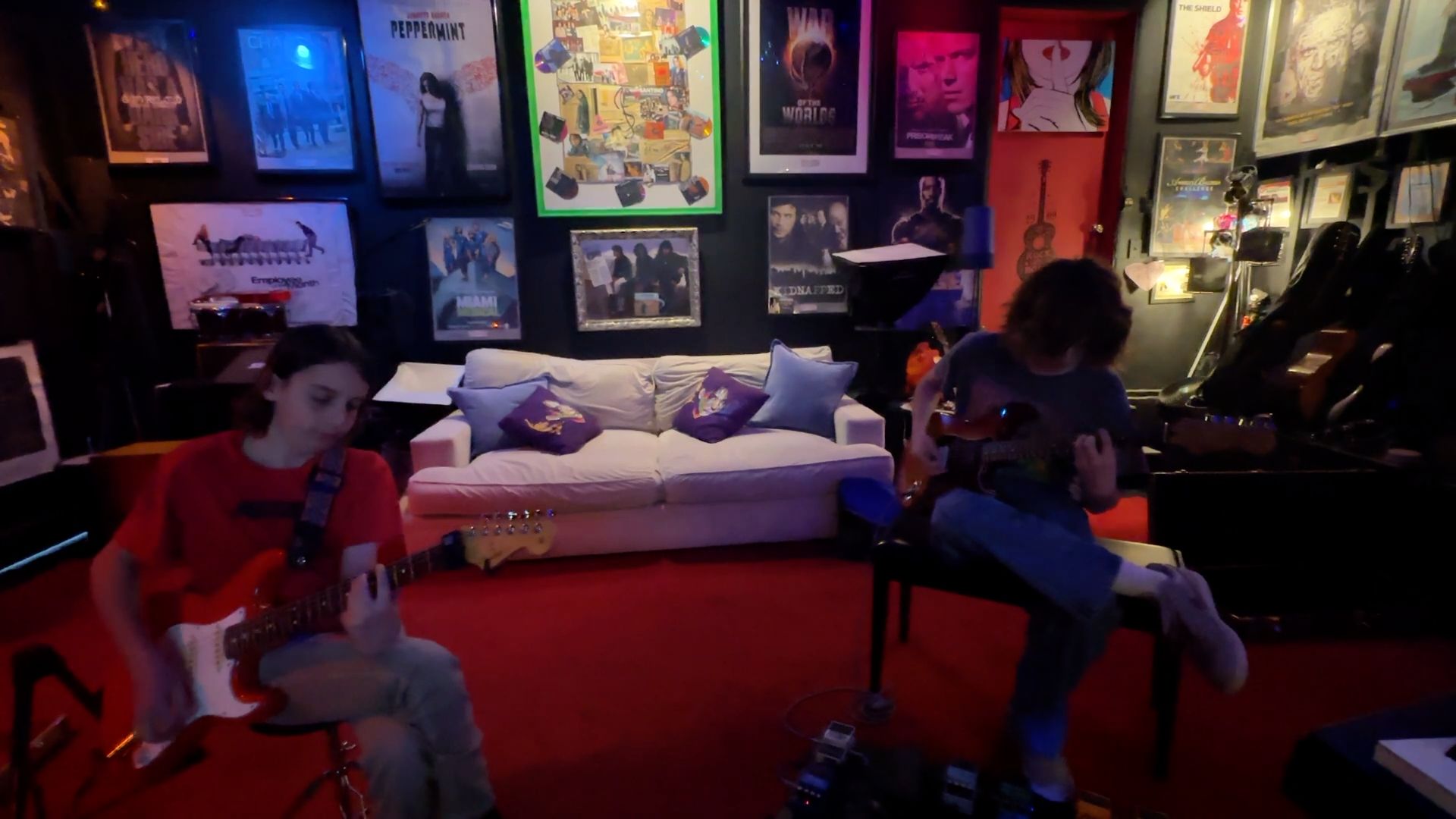 Two students playing electric guitar at Sound Strike Studio