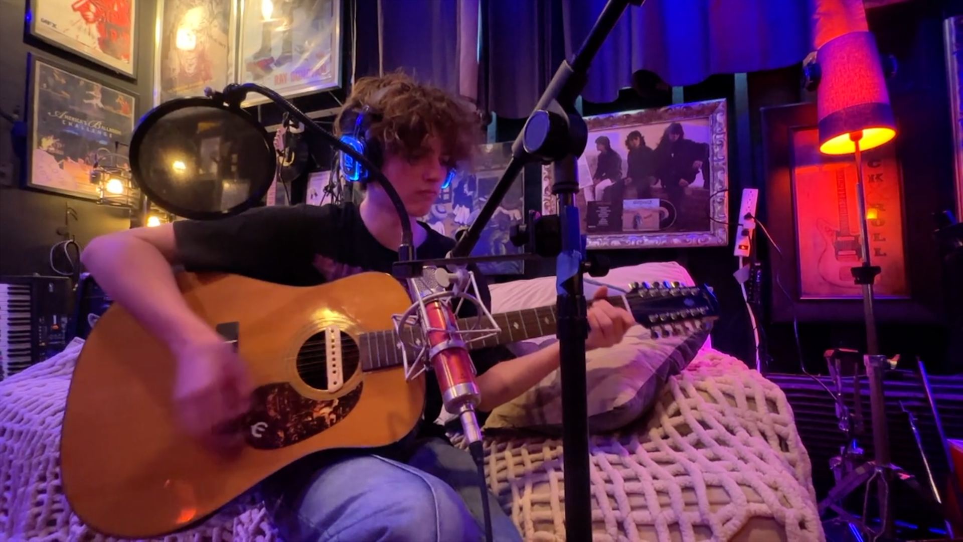 An artist recording a 12 string acoustic guitar