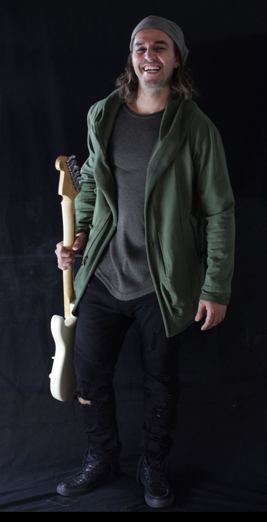 Santino De La Tore holding an electric guitar